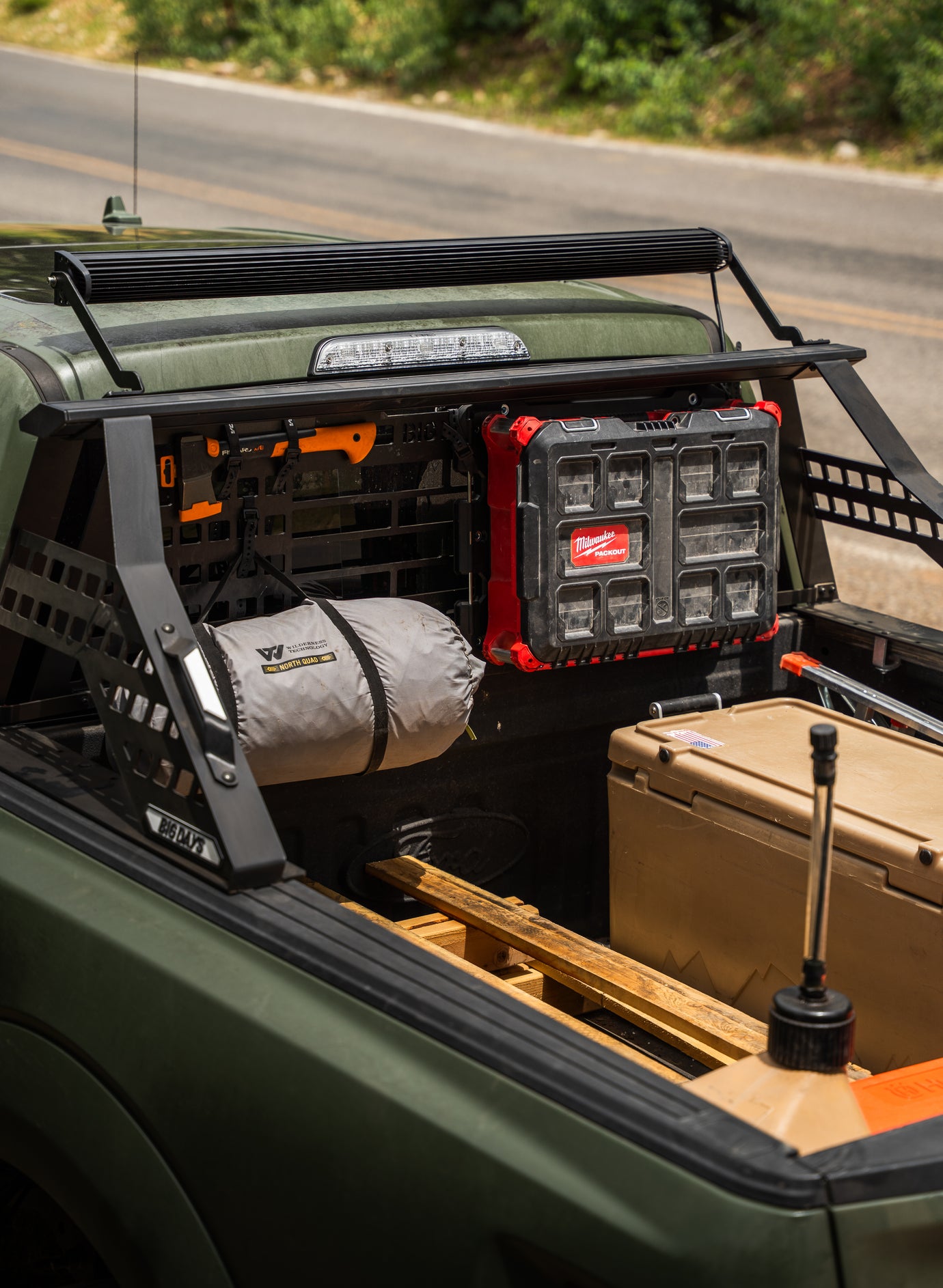 A chase rack or sport bar for Ford F150 with a headache rack, Molle panel, light bar, Milwaukee packet adapter for pickup truck bed 