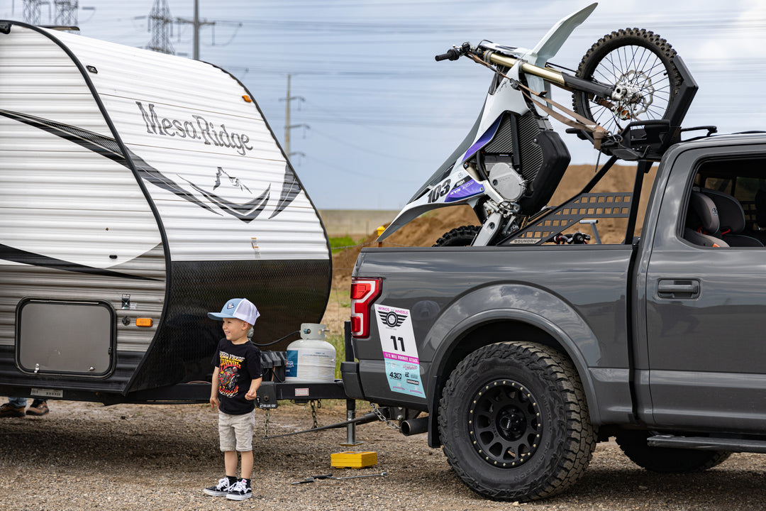 Towing a camper while hauling dirt bikes in a short bed pickup truck with Big Days Chase Rack System